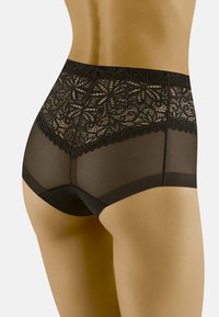 Sous-vêtements noirs taille haute avec des détails en dentelle florale au niveau de la taille et des panneaux transparents. Des bords en dentelle festonnée rehaussent le design.