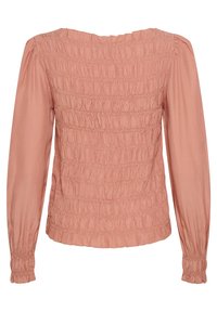 Rosa långärmad blus i blushfärg med smockad textur, pricken-mönstrad tyg och rynkade ärmavslut, med en vid halsringning och åtsittande silhuett.