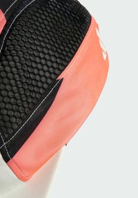 Cap features a combination of black mesh and pink fabric, with a geometric design and contrasting stitching. Soft texture with a sporty appearance.