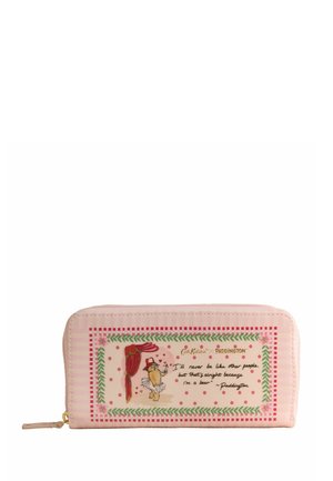 Pink zippered wallet with embroidered Paddington bear illustration and quote, bordered by green leaves and red checkered pattern.