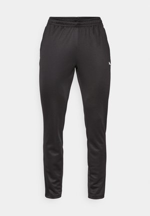 Pantalons de sport noirs avec une taille élastique, coupe ajustée, texture lisse et un petit logo blanc sur le côté gauche.