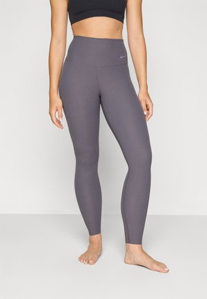 Høytlivede, ribbestrikkede leggings i en dempet lilla nyanse med en glatt finish og et lite emblem på livet. Myk, elastisk stoff.
