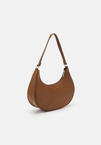 Bolso de mano marrón en forma de media luna con una sola correa y cierre de cremallera en un lado, situado sobre un fondo blanco liso.