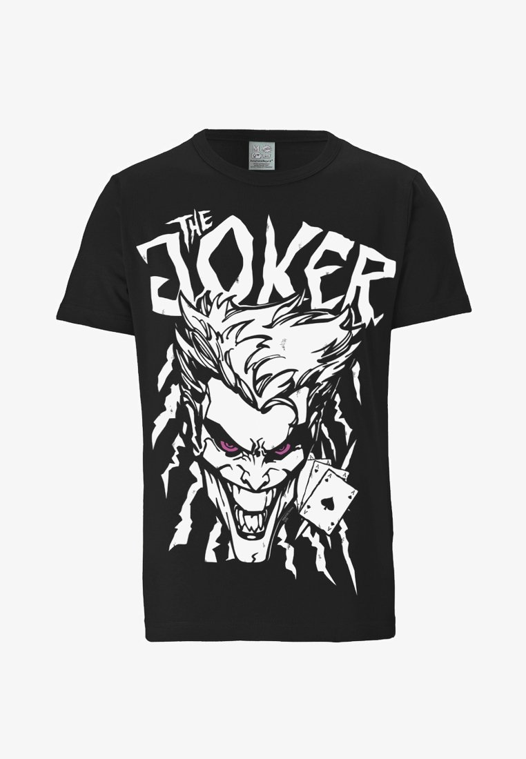 Black T-shirt with a white graphic of a sinister Joker face, glowing purple eyes, and three playing cards showing aces. "THE JOKER" text above.