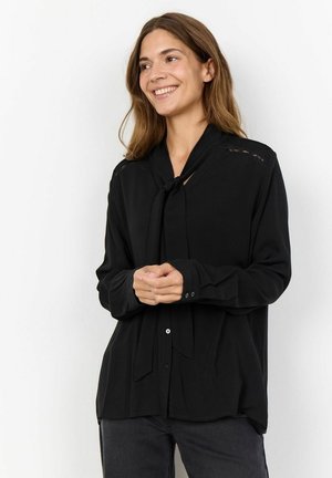 Black long-sleeve blouse with a tie collar, featuring lace detailing on the shoulders and a relaxed fit. Smooth fabric and button closure.