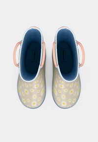 Light beige rubber boots with yellow and white daisy patterns, blue interior, and pink handles; rounded shape with decorative blue trim.