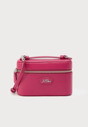 Rektangulær lyserød læder crossbody-taske med topbøjle, lynlåslukning og sølvfarvet hardware. Har en logoplaket på fronten.