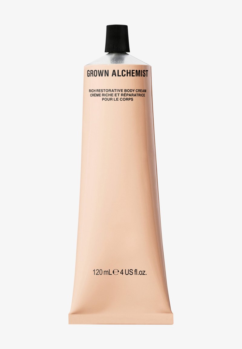 Gładka, metalowa tubka z bogatym regenerującym kremem do ciała; kolor brzoskwiniowy z czarnym napisem; pojemność 120 ml; zawiera wąski czarny korek.