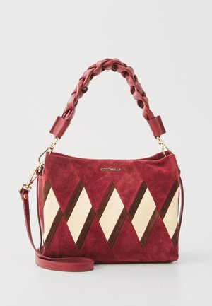 Red suede handbag featuring a braided top handle, diagonal cream and brown accents, and a detachable shoulder strap. Gold hardware.