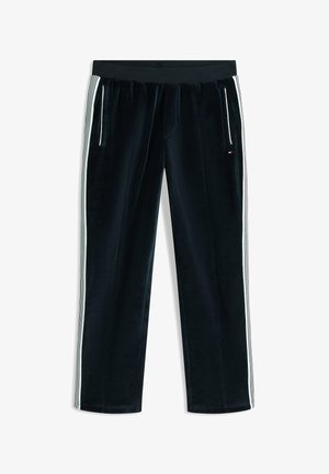 Black velour track pants with white side stripes, zippered front pockets, and elastic waistband, laid flat on a white background.