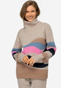 Pletený svetr s vysokým límcem, zdobený vícolorými vlnitými vzory v růžové, modré, béžové a námořnické modři. Měkká textura s žebrovanými manžetami.