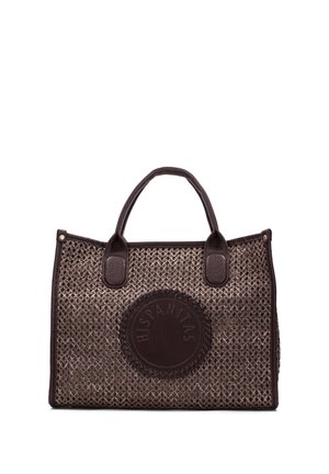 Bruine geweven draagtas met donkere leren handvatten en een ronde leren patch met het geperste woord "HISPANITAS" aan de voorkant.