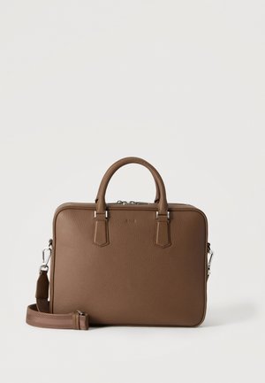 Porte-documents marron en cuir grainé, avec des poignées sur le dessus, une fermeture zippée et une bandoulière amovible, sur un fond uni.