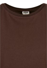 Braunes Baumwoll-T-Shirt mit Rundhalsausschnitt und kurzen Ärmeln. Glatte Textur mit schlichten Design und einem Etikett, das die Größe XS angibt.