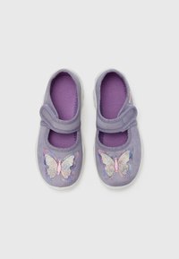 Purple fabric shoes with a stretchy strap, featuring a shiny butterfly design in pink and blue on the toe area and a textured inner lining.