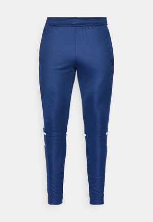 Marineblauwe sportbroek met een gladde, slanke textuur, voorzien van witte zijstrepen, een elastische tailleband en een taps toelopend ontwerp.