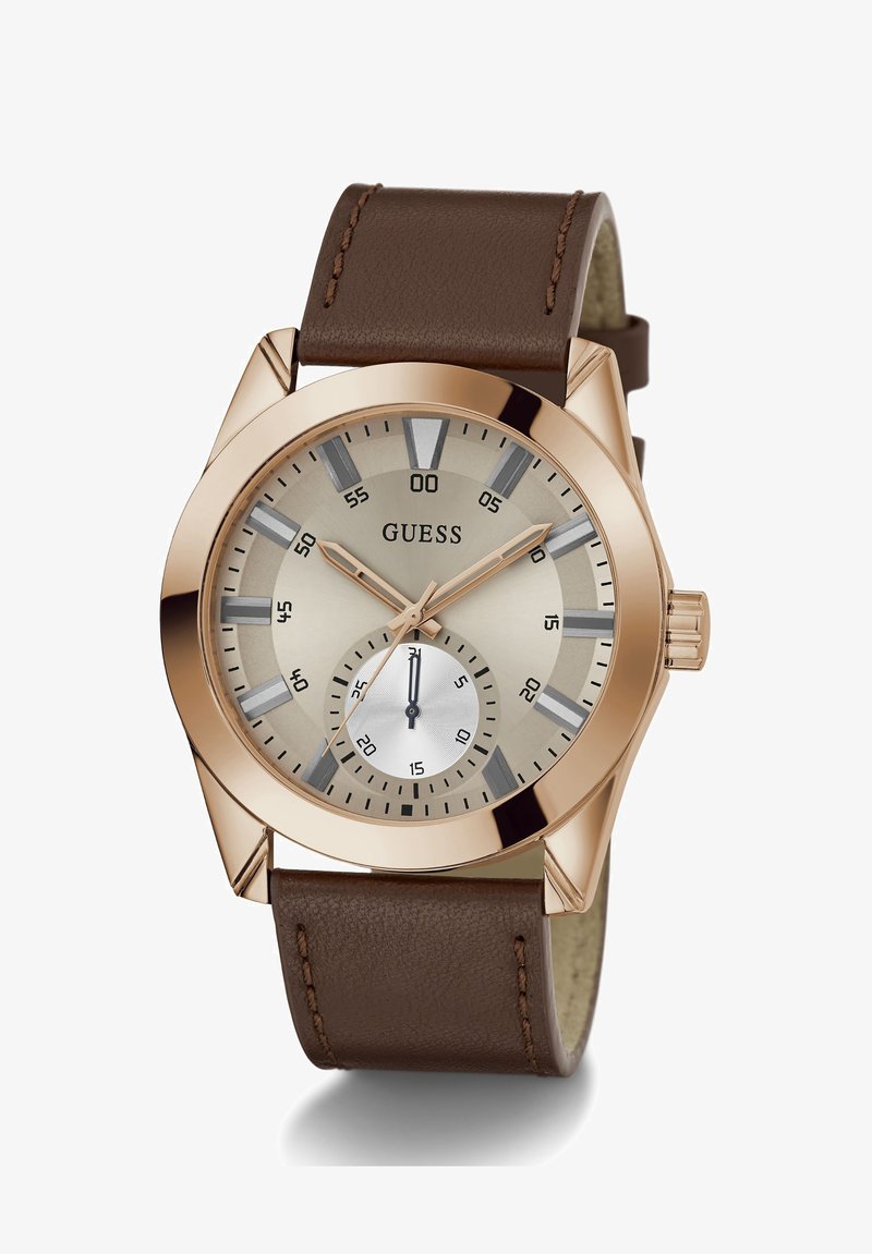 Relógio com pulseira de couro castanho, caixa de aço inoxidável rose gold, mostrador cinza claro, submostrador prateado e marcadores de horas destacados.
