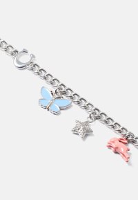 Silver chain bracelet featuring a blue butterfly charm, a rhinestone star, and a pink rabbit charm, showcasing varied textures and colors.