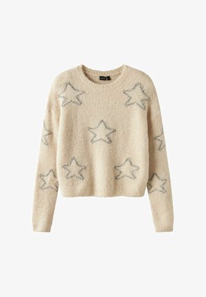 Bežs adīts džemperis ar apaļu kakla izgriezumu, īsu piegriezumu un pelēkām zvaigzņu detaļām visā virsmā. Mīksta tekstūra un ribotas piedurknes.