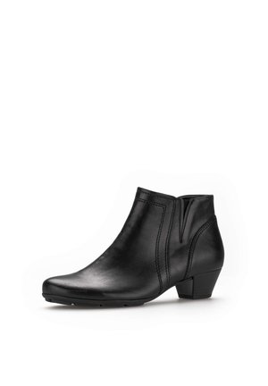 Bottine en cuir noir avec un bout arrondi, dotée de panneaux élastiques latéraux, de détails de couture subtils et d'un petit talon carré.