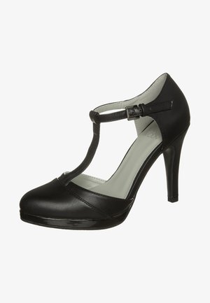 Zapato de tacón alto con tira en T de cuero negro, cierre de hebilla y punta cerrada y redondeada, con tacón de aguja delgado y suela con plataforma.