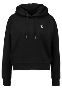 Sudadera negra recortada hecha de tela suave, con capucha ajustable con cordón, puños y dobladillo acanalados, y un pequeño logo blanco de Calvin Klein en el pecho.