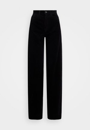 Pantalons en velours côtelé noir avec une taille haute, une coupe large, et une fermeture par un seul bouton sur le devant. Texture lisse avec des côtes verticales.