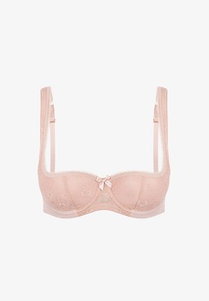 Beżowy koronkowy biustonosz o miękkiej fakturze, z fiszbinami, falistymi brzegami, regulowanymi ramiączkami i małą kokardką na środku z przodu.