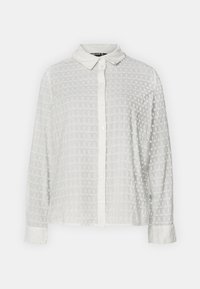 Camicia bianca con bottoni caratterizzata da un motivo testurizzato con piccoli design circolari, colletto e maniche lunghe con polsini abbottonati.