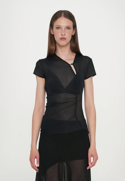 Black short-sleeved top made of sheer material, featuring a wrap design, asymmetrical neckline, and twisted detailing at the waist.