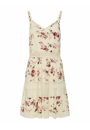 Robe fleurie en tissu crème avec des bretelles spaghetti, bordure en dentelle et volants empilés. Petits motifs floraux dans des nuances de rose et de vert.