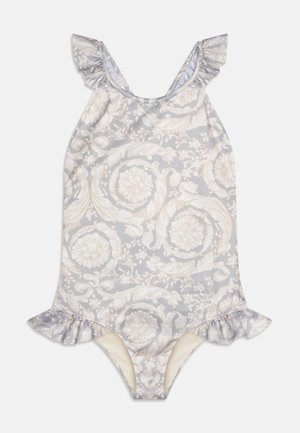 Enodelni kopalke z cvetličnim vzorcem v svetlo sivi in kremni barvi, z rahlo nabranimi naramnicami in obrobo. Mehka, raztegljiva tkanina. Srednje izrezana odprtina za noge.