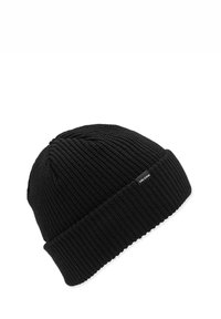 Bonnet en tricot noir avec une texture côtelée et un revers roulé. Présente une petite étiquette de marque sur le côté. Matériau durable et chaud.