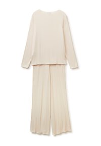 Beige souprava na volný čas s dlouhými rukávy a širokými nohavicemi, vyrobená z měkké, žebrované tkaniny s vlnkovanými okraji.