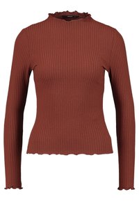 Haut à manches longues côtelé de couleur rouille, avec un col montant à volants et des ourlets légèrement ondulés aux manches et à la taille.