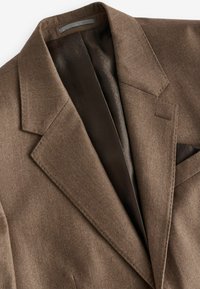 Brown wool blazer with notch lapels, single chest pocket, and a patterned lining. Smooth texture and tailored fit are notable features.