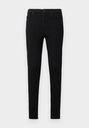 Jean skinny noir en tissu denim lisse. Dispose d'un design classique à cinq poches et d'une fermeture à bouton à la taille.