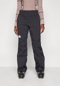 Svart vanntette skibukser med avslappet passform, som har sidelommer, forsterkede knepatcher og The North Face-logoen på venstre lår.