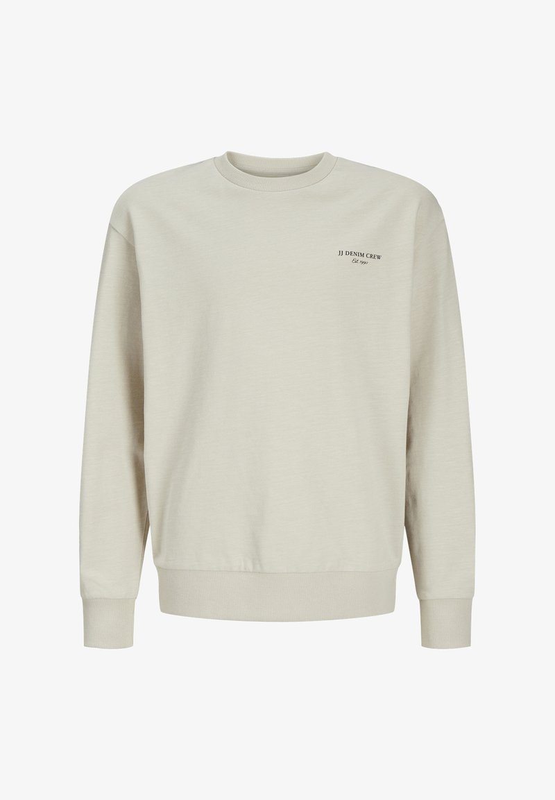 Light beige sweatshirt made of soft cotton blend. Features a ribbed neck and cuffs, with black text logo on the left chest area.