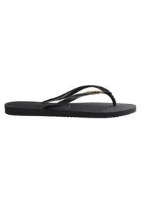 Zwarte flip-flop van rubber met een getextureerde voetbed, dunne bandjes en een gouden accent op het bovenste bandje. Platte, minimalistische ontwerp.