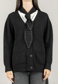 Cardigan nero in maglia con scollatura a V, maniche lunghe, due tasche e una sciarpa nera annodata decorativa con borchie argento.