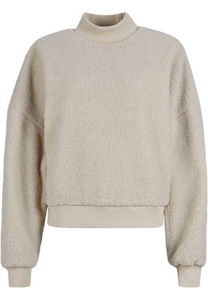 Maglione color crema con collo alto, realizzato in materiale pile testurizzato. Presenta un design cropped e polsini e orlo a coste.