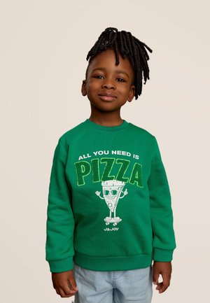 Sweatshirt vert avec "TOUT CE DONT VOUS AVEZ BESOIN, C'EST DE LA PIZZA" en lettres scintillantes, présentant une part de pizza en cartoon portant des lunettes de soleil. Le tissu semble doux et décontracté.