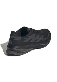 Schwarzer Laufschuh mit gepolsterter Sohle, drei seitlichen Streifen und Schnür-Design, leicht schräg auf weißem Hintergrund gezeigt.