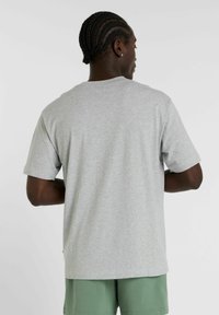 Grå bomulds T-shirt med korte ærmer og afslappet pasform, med rund halsudskæring og glat tekstur. Synlige syninger.