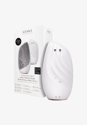 Sonic ansigtsbørste og ansigtsløfter i hvid, med en buet ergonomisk form, tekstureret overflade og to metalknapper på forsiden.