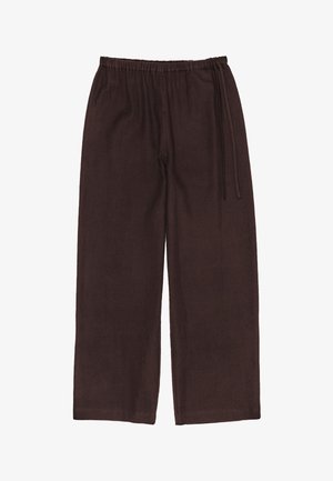 Tumši brūni, platā kāju bikses, izgatavotas no fakturēta auduma. Elastīga josta ar auklu, lai pielāgotu izmēru. Nav redzamu kabatu.