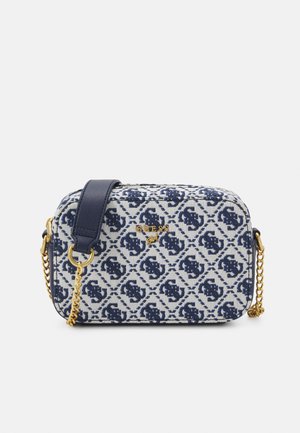 Compact rectangular crossbody bag with blue and white patterned fabric, navy leather strap, gold chains, and gold "GUESS" logo on front.