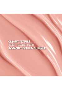 Kremet tekstur i rosegullfinish med en umiddelbar gyllen glans, med glatte, buede linjer og en blank overflate.