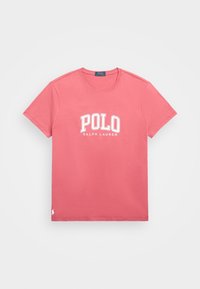 Rosa bomulls t-shirt med en vit "POLO RALPH LAUREN" logotyp, rundad halsringning, korta ärmar och en liten hästlogotyp vid fållen.